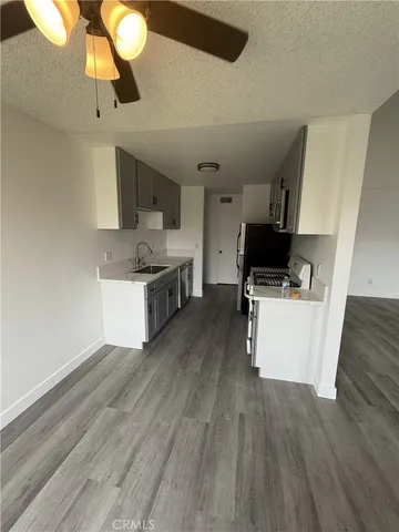 a kitchen with a sink appliances and cabinets