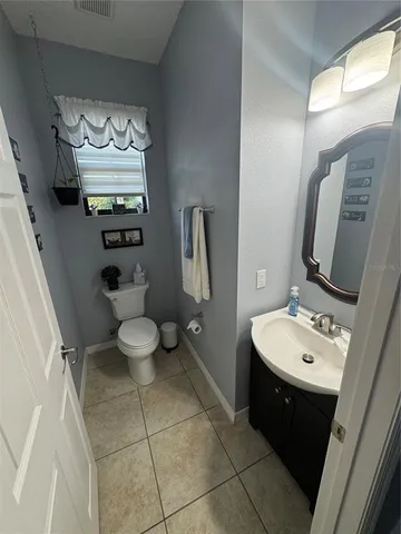 a view of a hallway with wooden floor and windows