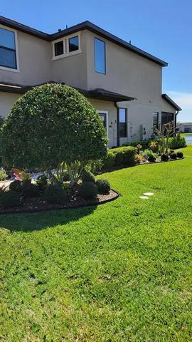 a front view of a house with garden