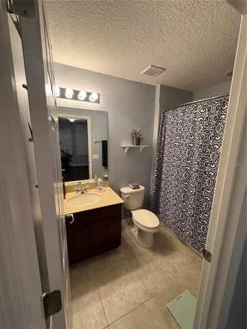 a kitchen with a refrigerator and a stove top oven