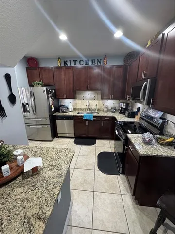 a view of gym equipment with sitting area
