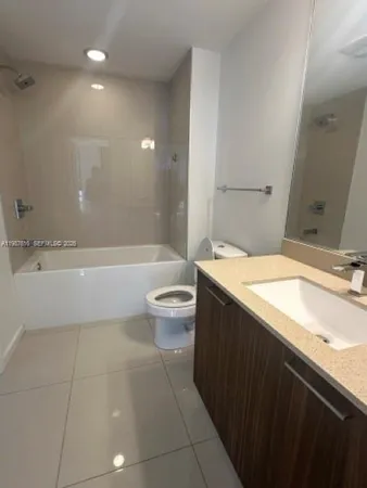 a bathroom with a sink a large mirror and a mirror