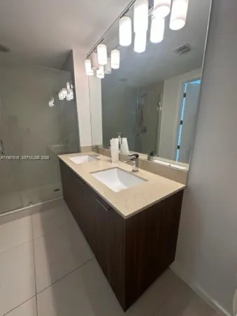 a bathroom with a shower a sink a toilet and a shower
