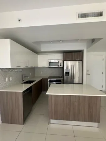 a kitchen with kitchen island cabinets and oven