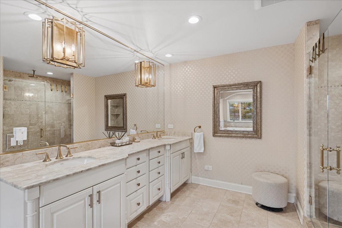 14840 Creekside Path Green Oaks, IL 60048 - Photo 18 of 35 a spacious bathroom with a granite countertop double vanity sink a mirror and a