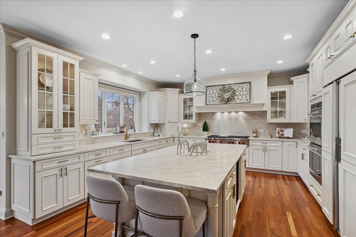 14840 Creekside Path Green Oaks, IL 60048 - Photo 3 of 35 a kitchen with kitchen island a stove a table and chairs in it