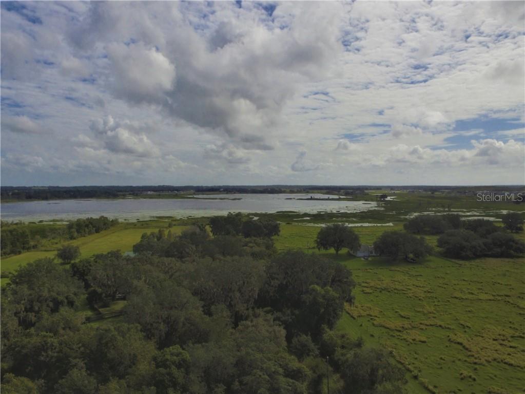 9122 Kenton Road Wesley Chapel, FL 33545 - Photo 1 of 1 AERIAL OF PROPERTY -- LAKE ON THE EAST SIDE OF PROPERTY