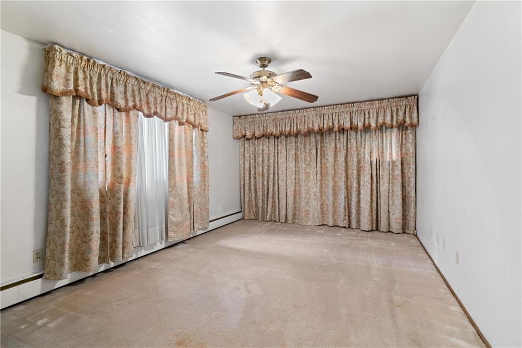 500 Allenby Avenue Pittsburgh, PA 15218 - Photo 16 of 35 an empty room with windows and a chandelier fan