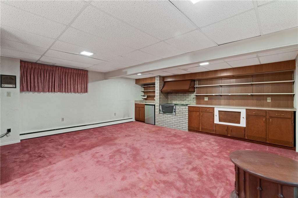 500 Allenby Avenue Pittsburgh, PA 15218 - Photo 20 of 35 a view of an empty room with a kitchen