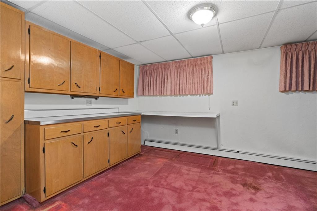 500 Allenby Avenue Pittsburgh, PA 15218 - Photo 22 of 35 a kitchen with granite countertop cabinets and window