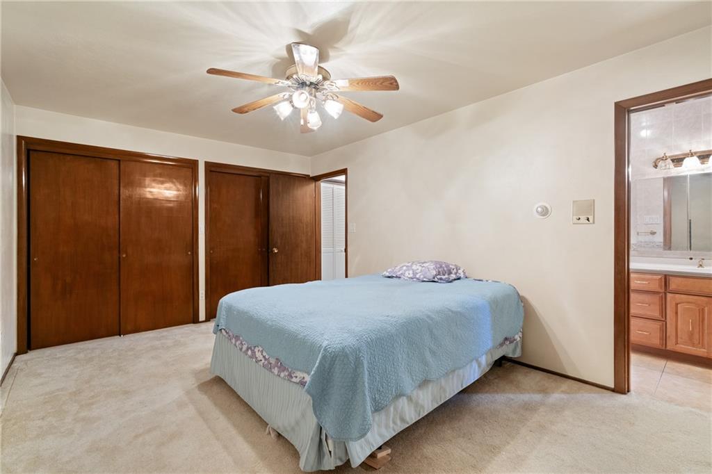 500 Allenby Avenue Pittsburgh, PA 15218 - Photo 9 of 35 a bedroom with a large bed and a chandelier