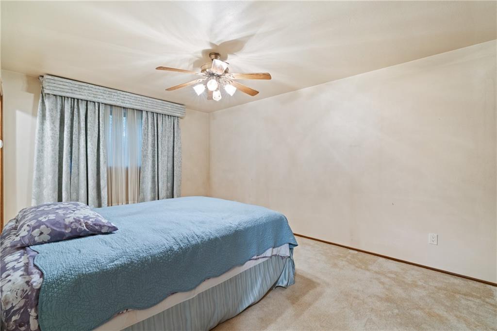 500 Allenby Avenue Pittsburgh, PA 15218 - Photo 10 of 35 a bedroom with a bed and a chandelier