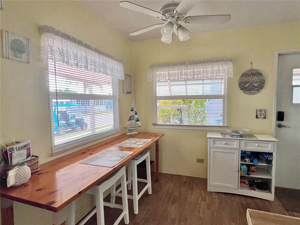 1100 South Belcher Road, Unit 260 Largo, FL 33771 - Photo 17 of 79 a dining room with a window wooden floor and a chandelier
