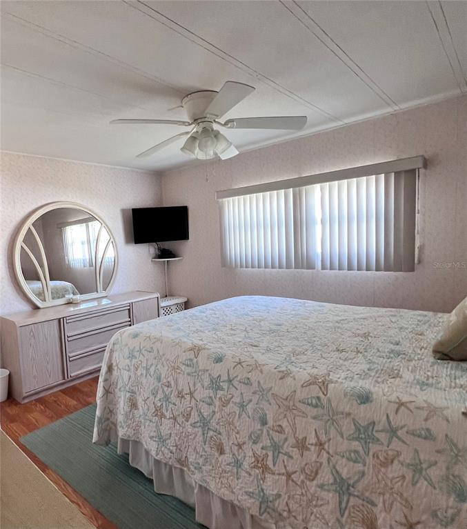 1100 South Belcher Road, Unit 260 Largo, FL 33771 - Photo 23 of 79 a spacious bedroom with a large bed and a chandelier