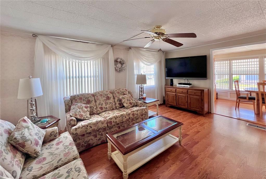 1100 South Belcher Road, Unit 260 Largo, FL 33771 - Photo 24 of 79 a living room with furniture and a flat screen tv