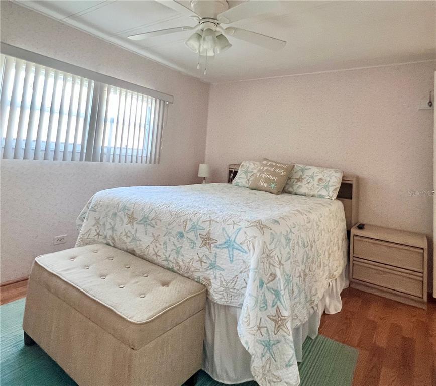 1100 South Belcher Road, Unit 260 Largo, FL 33771 - Photo 26 of 79 a bedroom with a bed and a chandelier
