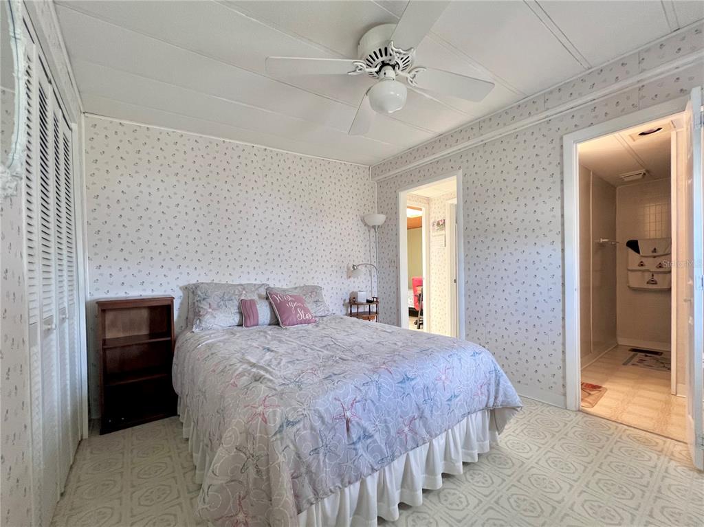 1100 South Belcher Road, Unit 260 Largo, FL 33771 - Photo 39 of 79 a bedroom with a bed and a chandelier