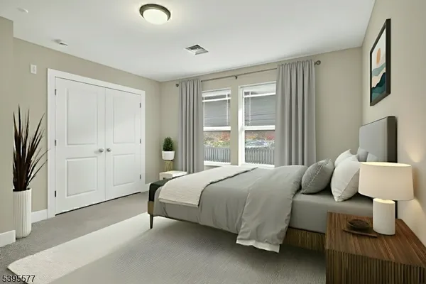 a living room with furniture a flat screen tv and a window