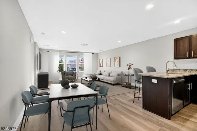a living room with furniture a flat screen tv and a window