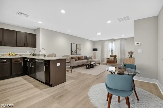 a spacious bedroom with a bed a table and chair