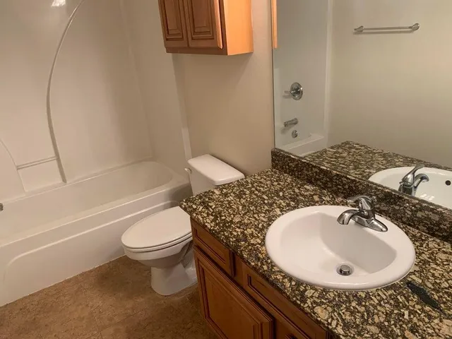 a bathroom with a sink a toilet and bathtub