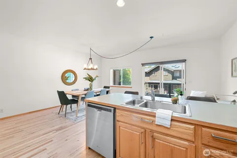 a view of a kitchen and a dining table chairs