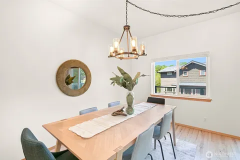 a view of a dining room with furniture and chandelier