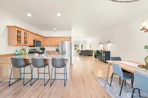 a dining room with furniture and wooden floor