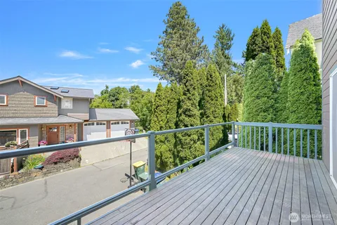 a view of a balcony with wooden floor and fence