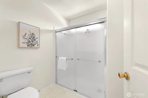 a bathroom with a shower and a toilet