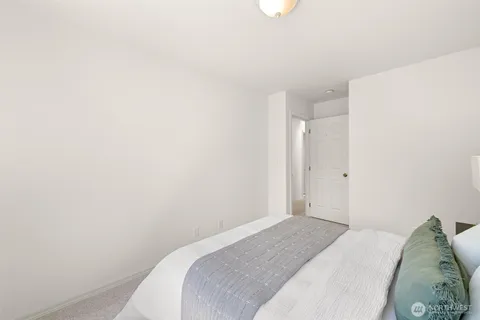 a bedroom with a bed and a wall painting