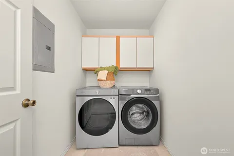 a utility room with sink dryer and washer