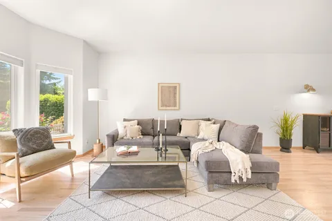 a living room with furniture and a lamp