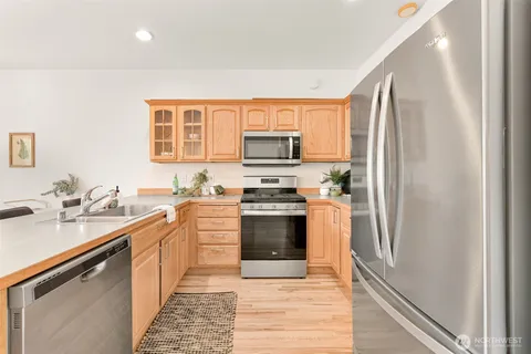 a kitchen with stainless steel appliances granite countertop a refrigerator stove and sink