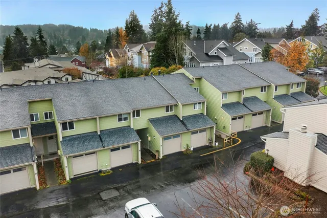 a aerial view of a house with a yard and sitting area