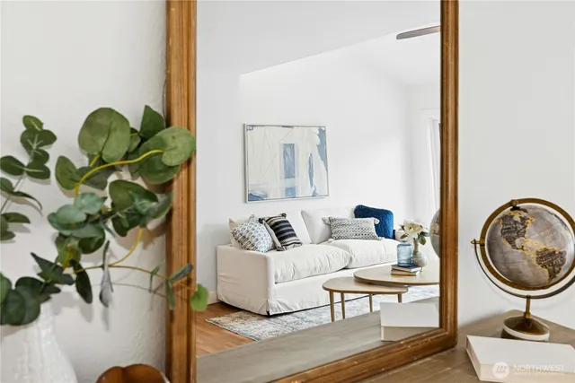 a living room with furniture and a potted plant