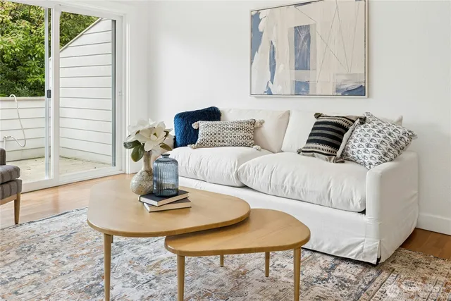 a living room with furniture and a potted plant