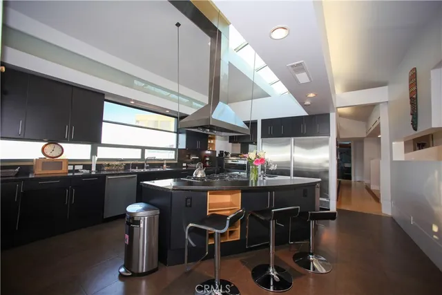 a kitchen with granite countertop a sink appliances cabinets and dining table
