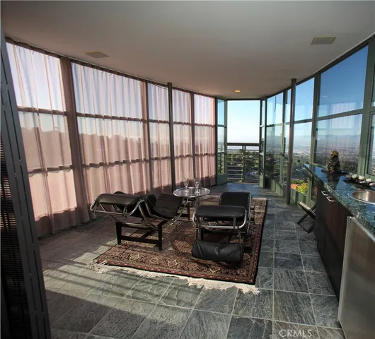 a dining room with furniture and a floor to ceiling window