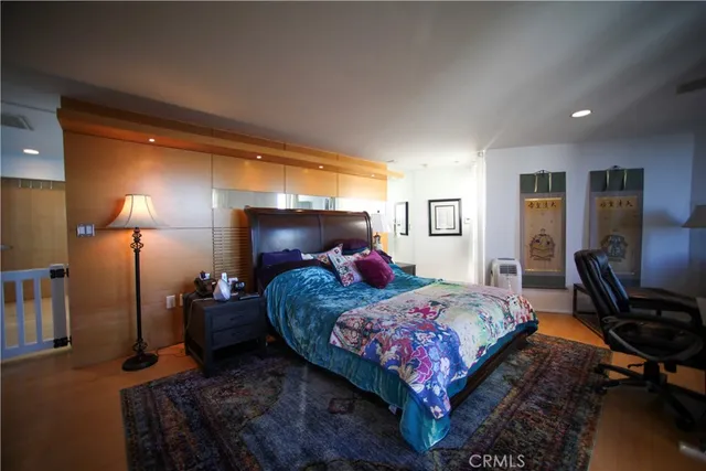 a bedroom with two beds and a flat screen tv