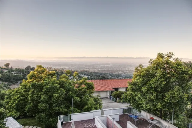 an aerial view of a house with a yard and mountain view in back
