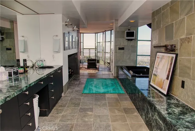 a large bathroom with a tub a sink and a mirror
