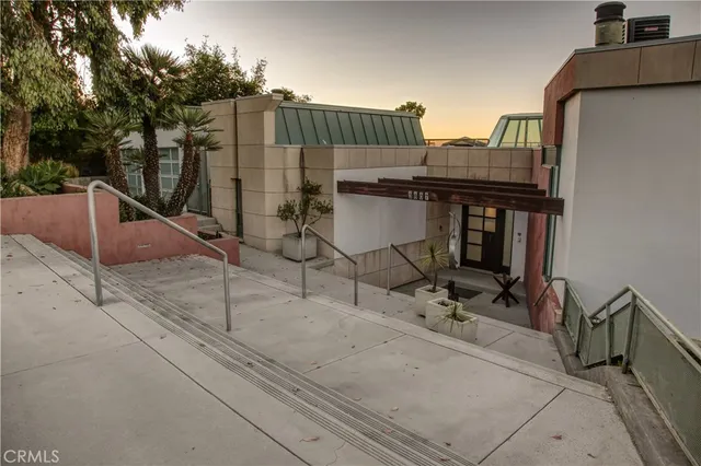 a roof deck with table and chairs a barbeque