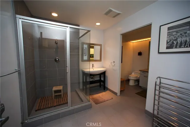 a bathroom with a sink and mirror with toilet