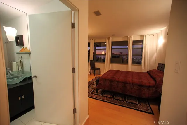 a bed room with a bed and dresser with mirror