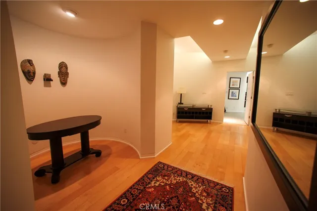 a view of hallway with stairs and wooden floor
