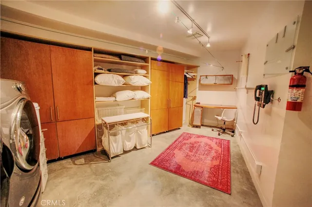 a living room with a table chairs and a refrigerator