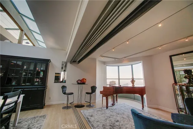 a living room with furniture a window and gym equipment