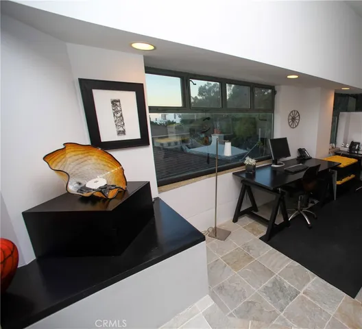 a living room with furniture and a painting on the wall