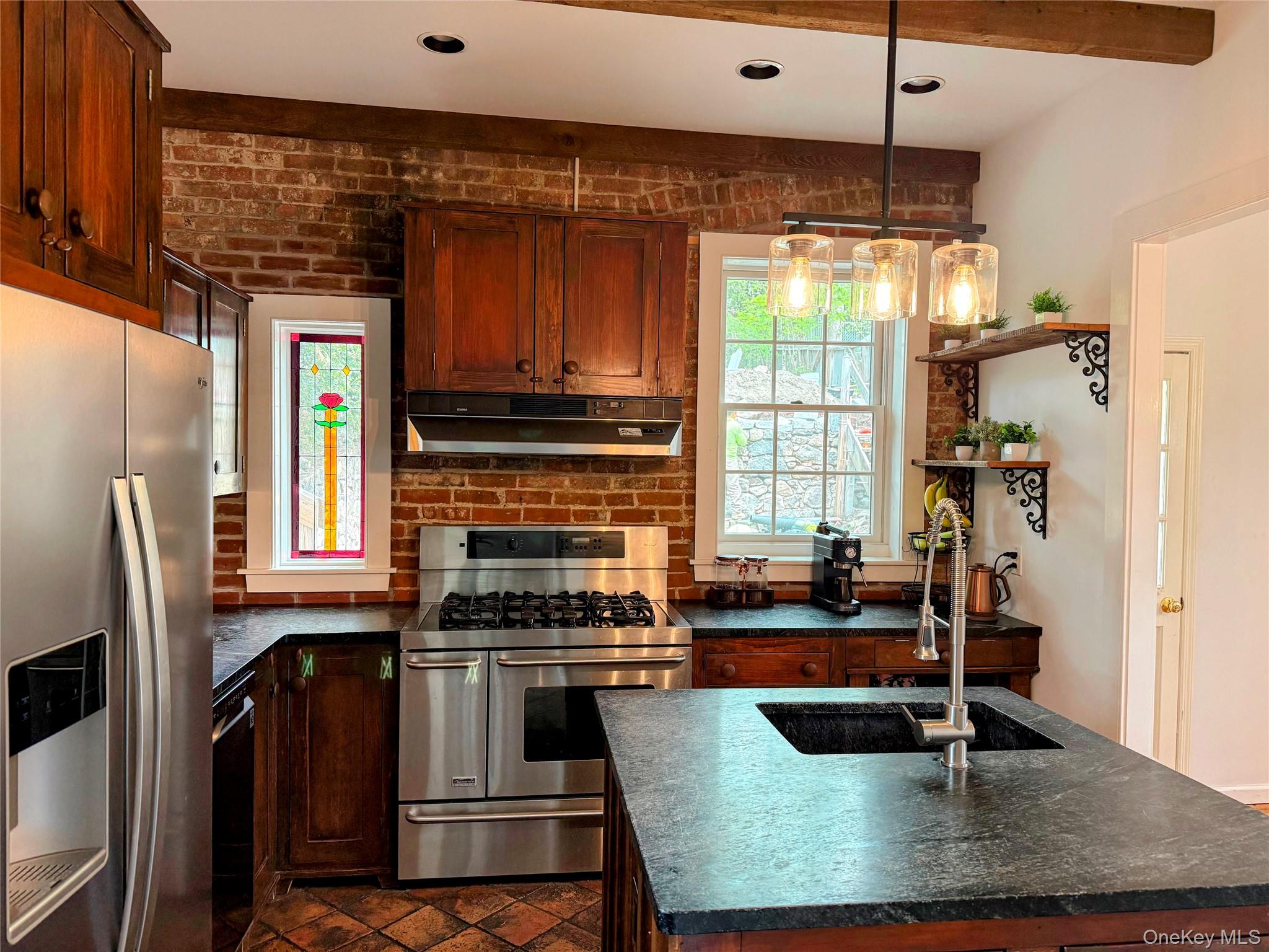 6 Church Street Cold Spring, NY 10516 - Photo 3 of 15 a kitchen with granite countertop a stove a sink and a refrigerator